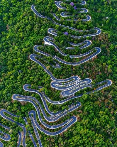 Hairpin bends winding up the green hills